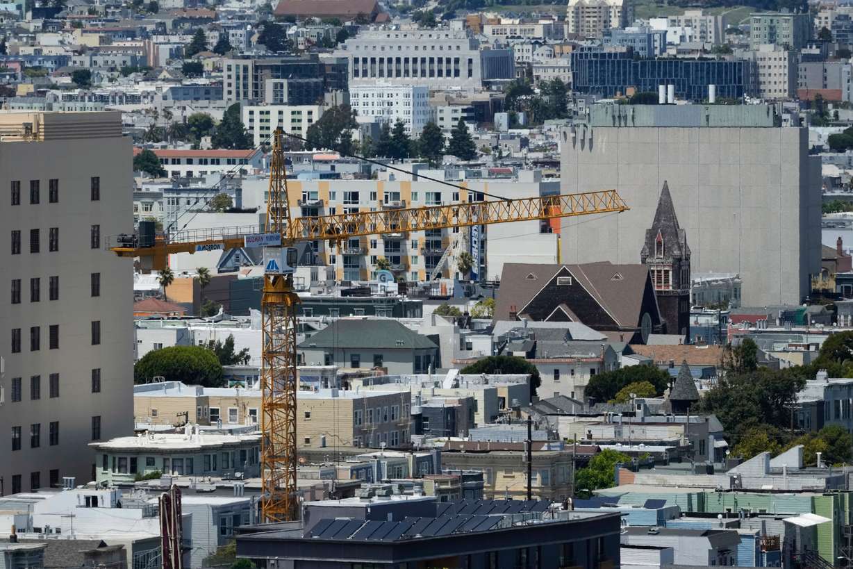 A crane rises over properties while being used at a construction site for a new housing development in San Francisco, July 18, 2025. Housing prices reached its highest level in San Francisco, according to a new Redfin analysis.