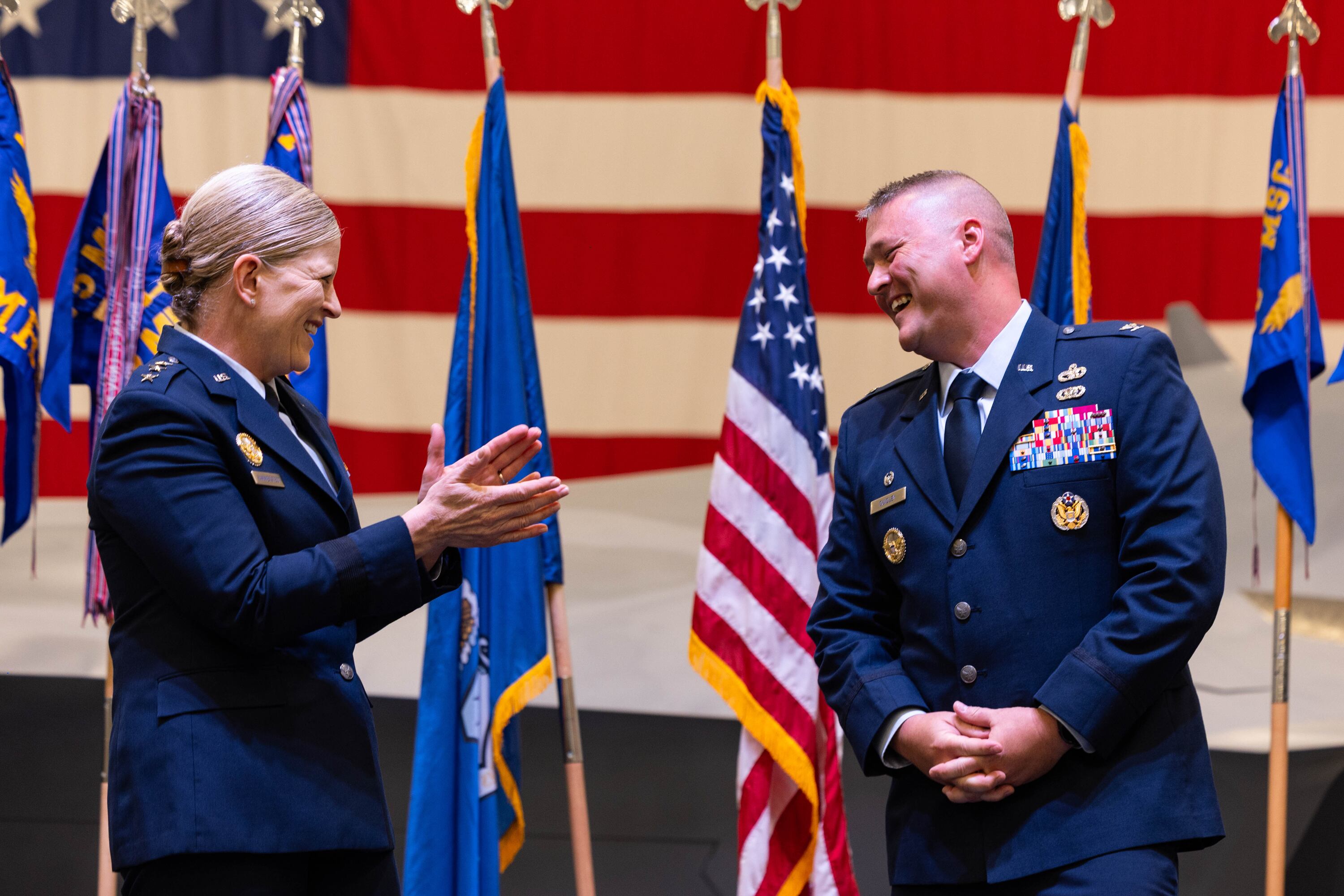 Col. Eric B. Quidley smiles as Lt. Gen. Jennifer Hammerstedt applauds him for his new position during a change of command ceremony at the Hill Aerospace Museum on Monday.