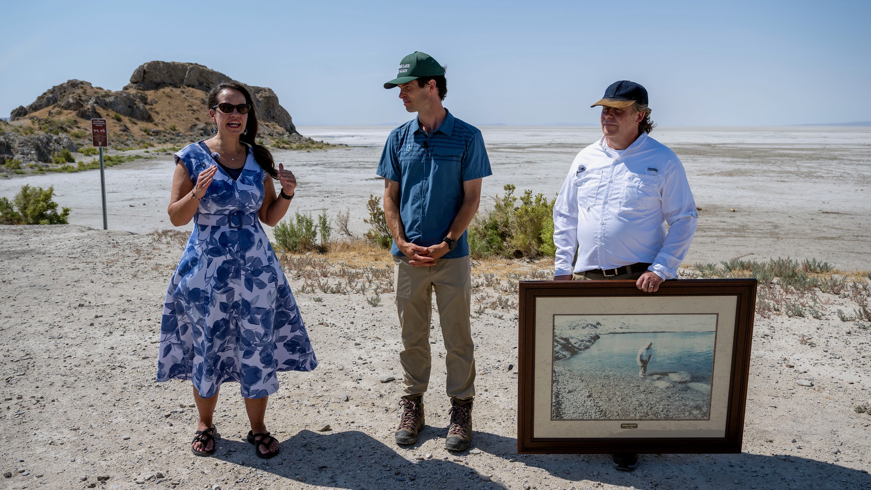 Rhonda Lauritzen, Ben Abbott and Val Anderson are pictured Monday near Lone Rock in the dry bed of the Great Salt Lake. Lake water used to surround the rock, a stopping point on a tour of the area on Monday led by opponents of the proposed Box Elder County data center proposal.