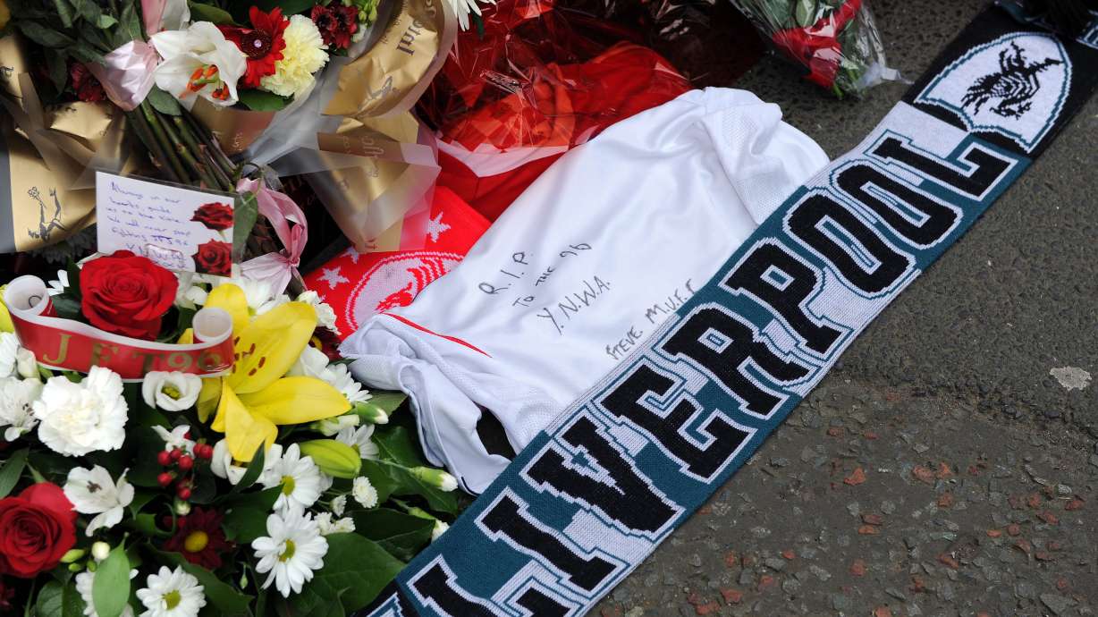 FILE -Tributes are laid at the memorial of the Hillsborough disaster outside Anfield before the English Premier League soccer match between Liverpool and Manchester City at Anfield in Liverpool, England, April. 13, 2014.