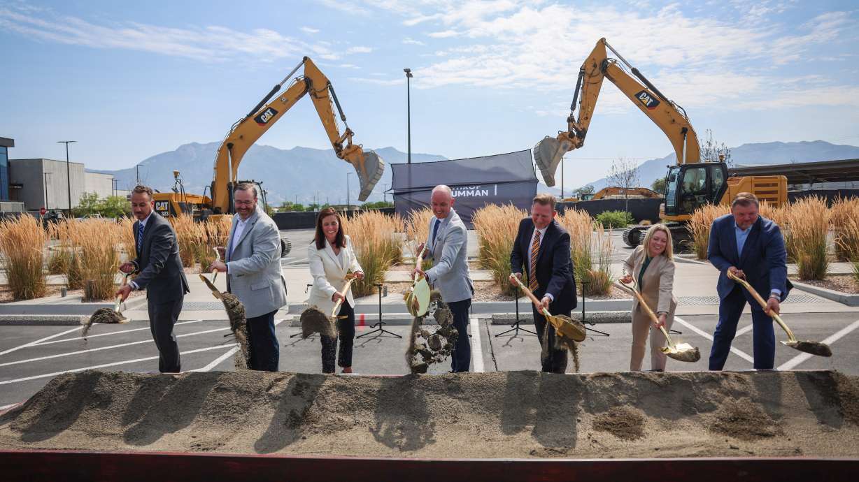 Gov. Spencer Cox and others pose with construction machinery during the Roy Innovation Center Legacy Building groundbreaking in Roy on Tuesday. A Northrop Grumman official said the Sentinel nuclear defense system is moving ahead with plans for flight tests next year.