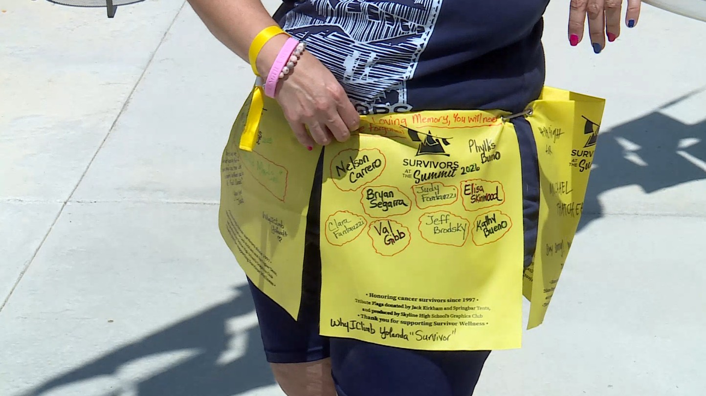 Yolanda Carrero, 11-year cancer survivor, shows the flags she wears at the Survivors at the Summit event.