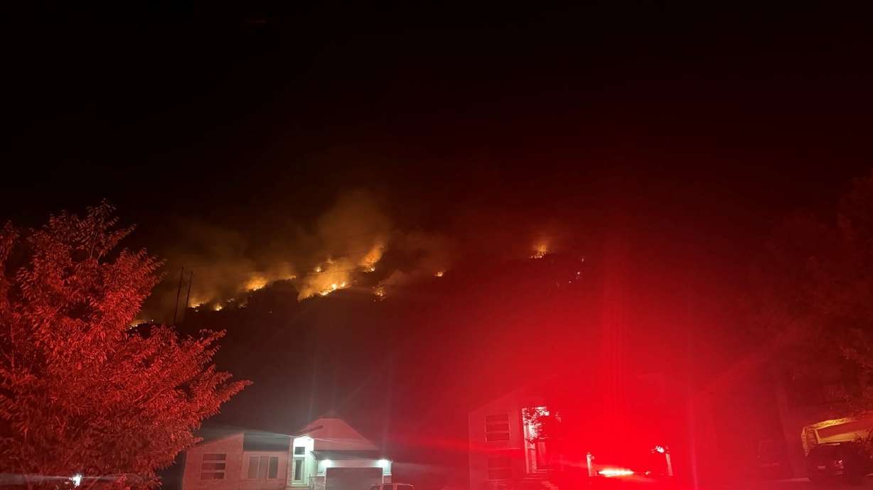 Firefighters work to control an 18.1-acre human-caused blaze on Saturday. A 51-year-old man faces a misdemeanor charge after authorities say he sparked the Mountain Road Fire.