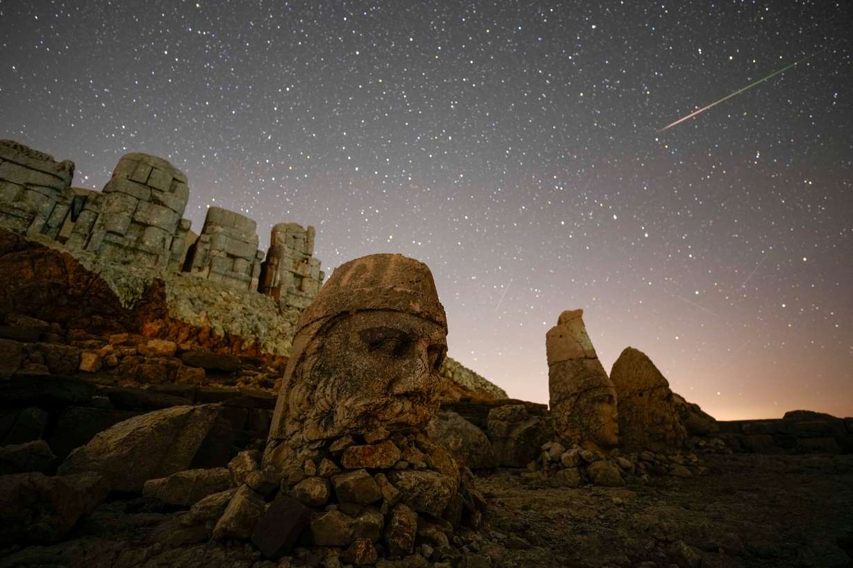 Ancient statues are seen during the Perseid meteor shower atop Mount Nemrut in southeastern Turkey, Aug.11, 2024. Perched at an altitude of 2,150 meters (over 7,000 feet), the statues are part of a temple and tomb complex that King Antiochus I, of the ancient Commagene kingdom, built as a monument to himself.