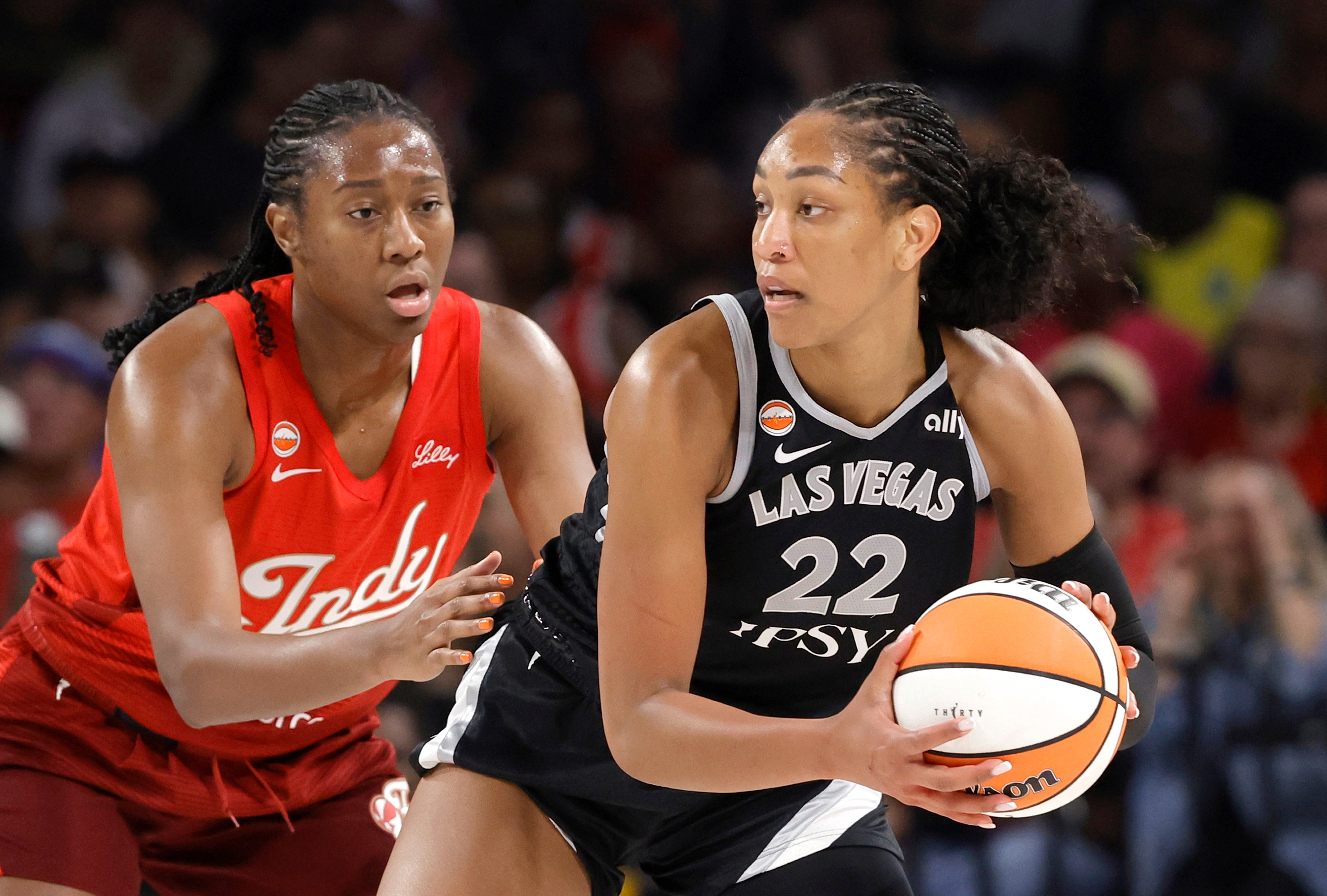 Indiana Fever center-forward Aliyah Boston, left, defends against Las Vegas Aces center A'ja Wilson (22) during the first half of an WNBA basketball game Sunday, July 12, 2026, in Las Vegas. 