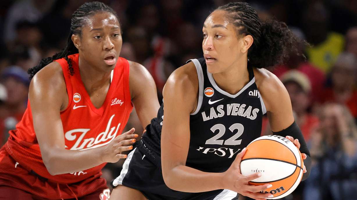 Indiana Fever center-forward Aliyah Boston, left, defends against Las Vegas Aces center A'ja Wilson (22) during the first half of an WNBA basketball game Sunday, July 12, 2026, in Las Vegas.