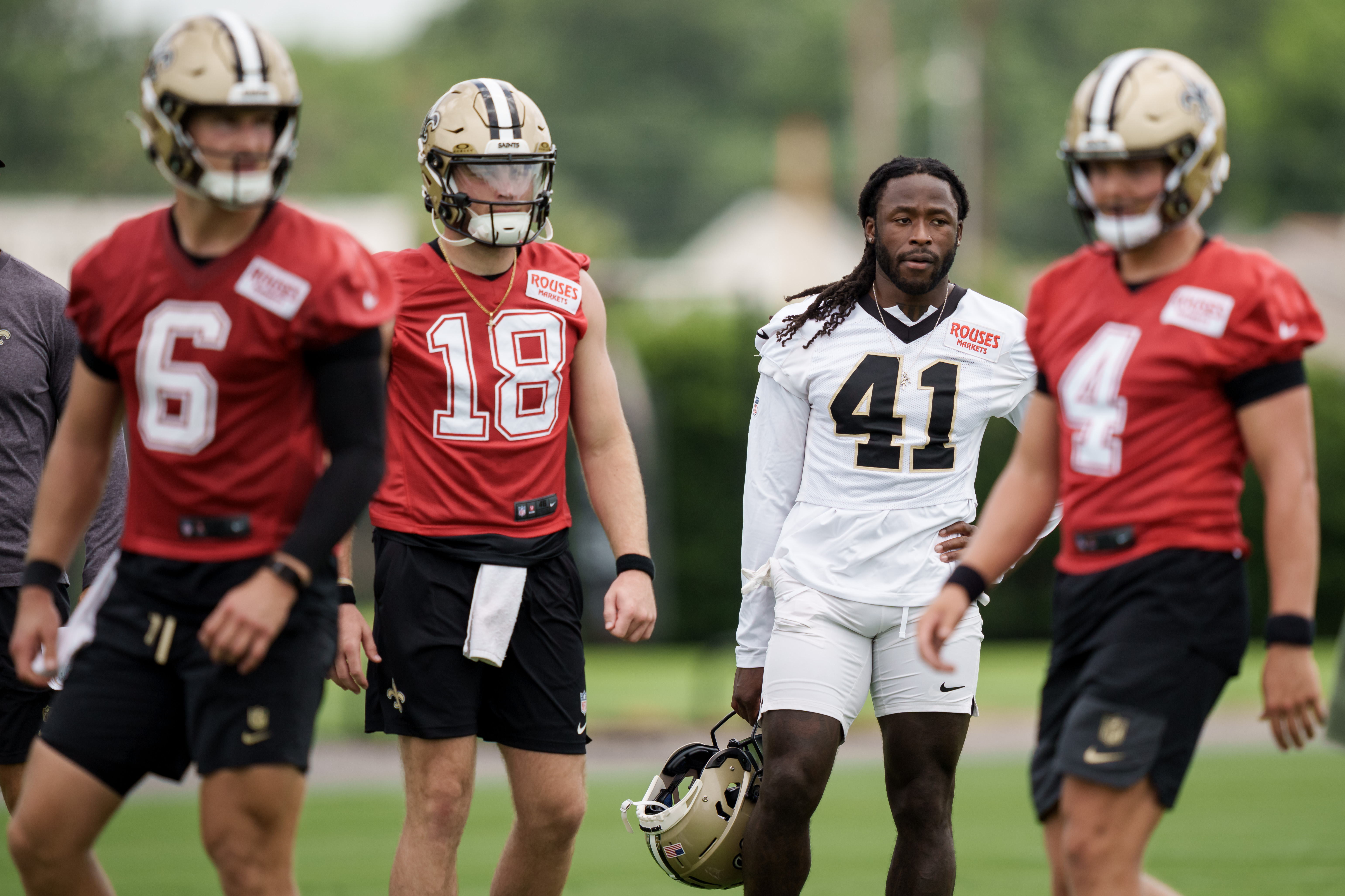 New Orleans Saints running back Alvin Kamara (41), second right, watches practice with quarterback Hunter Dekkers (18), second left, during the NFL football team's practice in Metairie, La., Wednesday, June 17, 2026. 