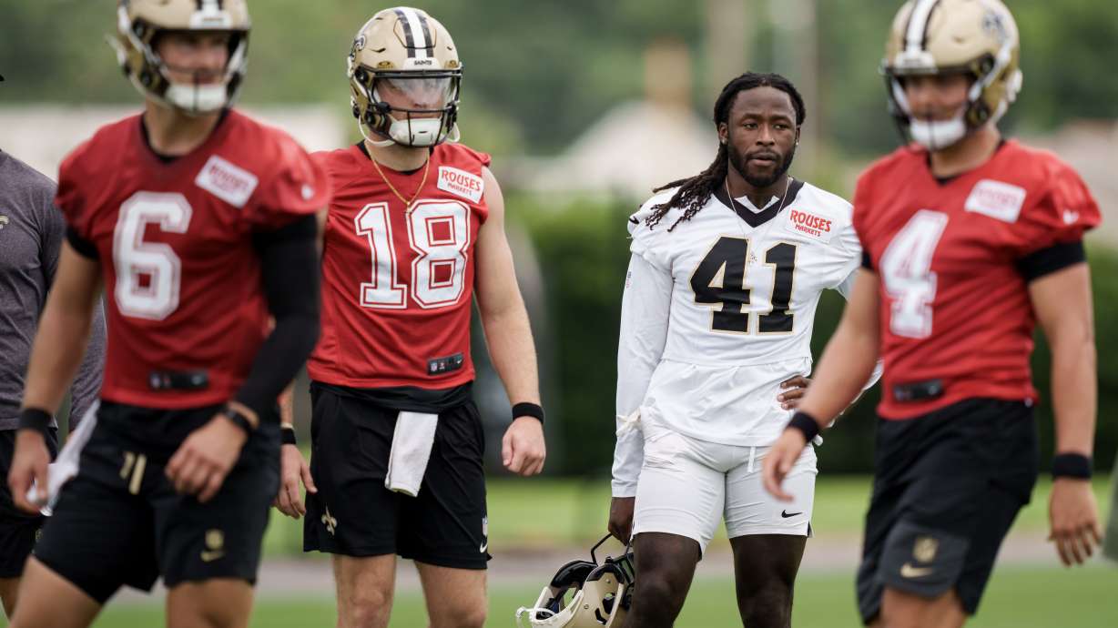 New Orleans Saints running back Alvin Kamara (41), second right, watches practice with quarterback Hunter Dekkers (18), second left, during the NFL football team's practice in Metairie, La., Wednesday, June 17, 2026.
