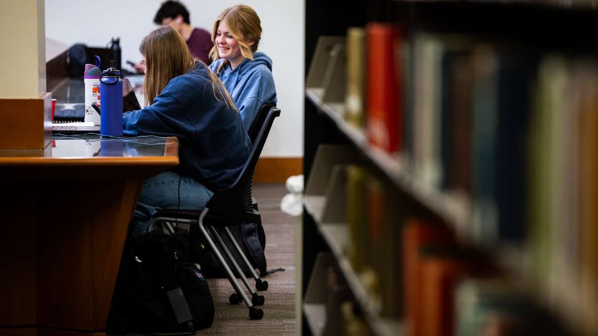 University of Utah students Brielle Lott, 18, center, and Teagan Sutherland, 19, left, work at the J. Willard Marriott Library in Salt Lake City on April 1.