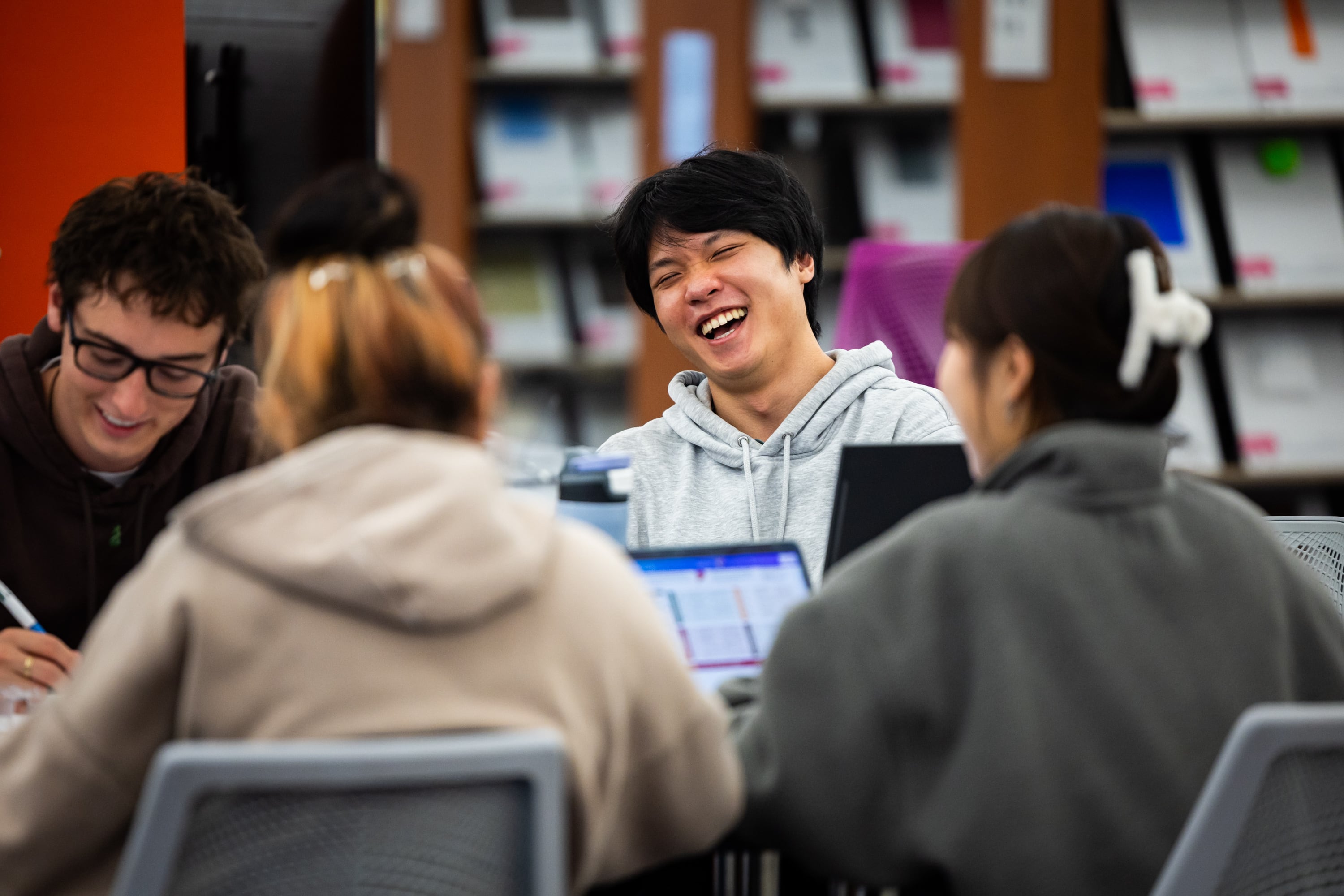 University of Utah student James Hwu, 21, center, works with friends at the J. Willard Marriott Library in Salt Lake City on April 1.