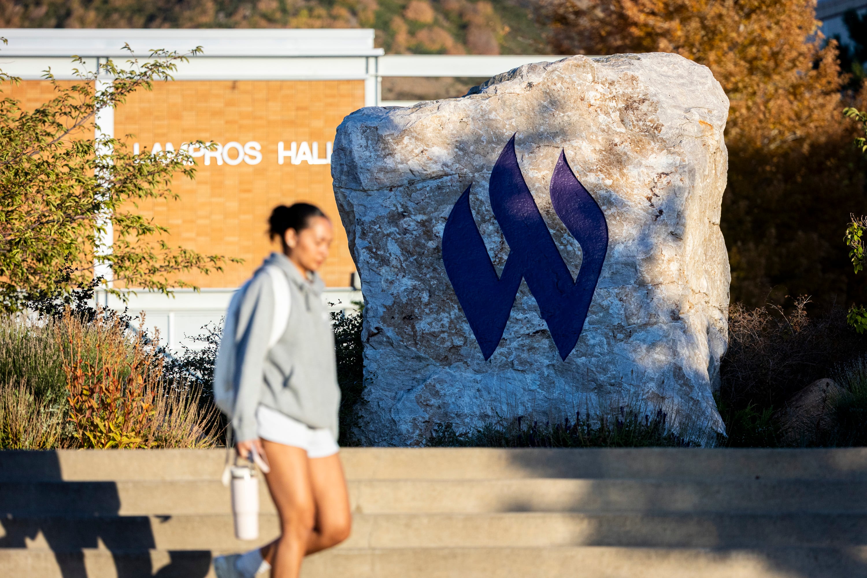 A student passes by the Flaming "W" Rock on the campus of Weber State University in Ogden on Oct. 1, 2025.