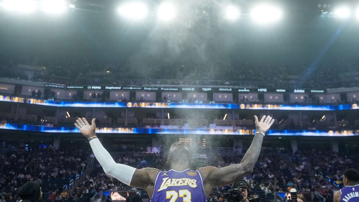 FILE - Los Angeles Lakers forward LeBron James throws chalk in the air before an NBA basketball game against the Golden State Warriors in San Francisco, April 9, 2026.