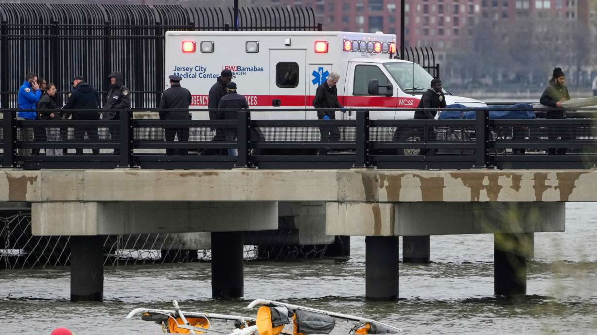 Emergency personnel respond to a helicopter crash on the Hudson River, April 10, 2025, in Jersey City, N.J. A National Transportation Safety Board report on Thursday said the remains of several geese were found on the wreckage of the chopper.
