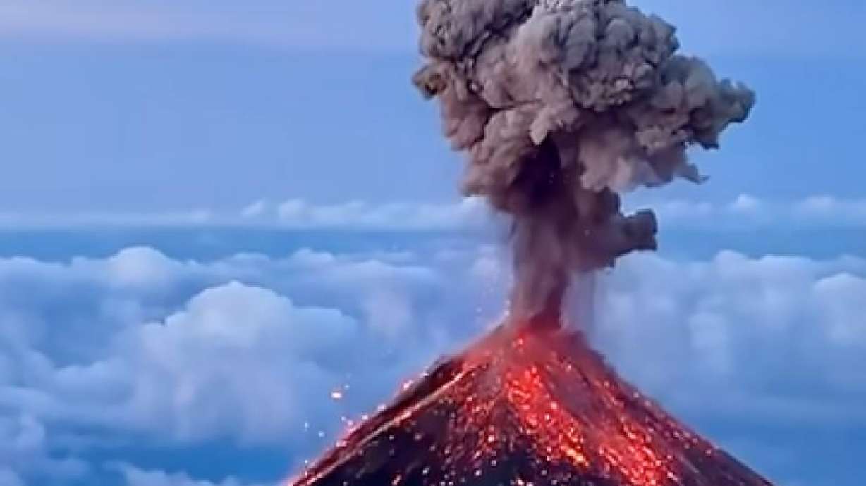 A volcano in Guatemala erupts at sunrise this June. Chase Boehringer climbed 14,000 feet at the summit of Acatenango Volcano to capture it.