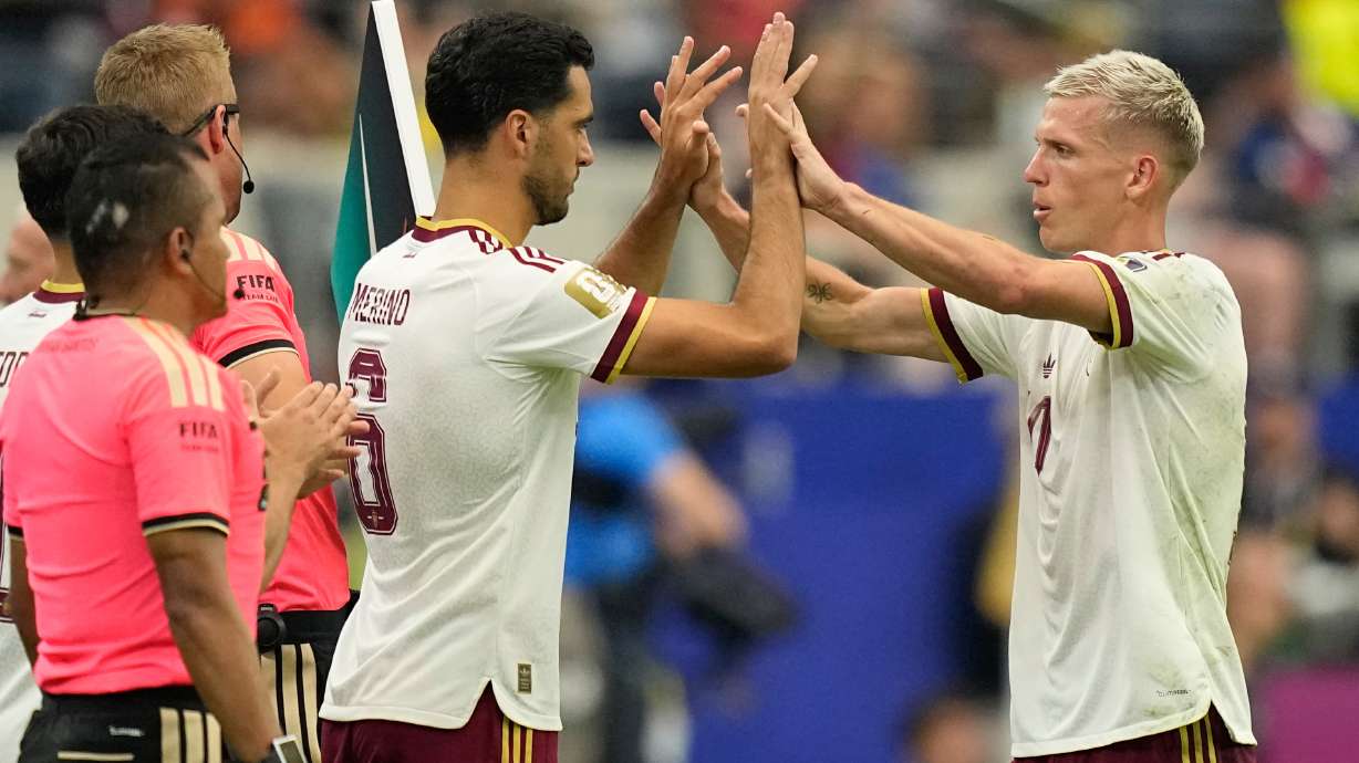 Spain's Dani Olmo, right, greets teammate Mikel Merino (6) as Olmo is replaced by Merino during the World Cup semifinal soccer match between France and Spain in Arlington, Texas, near Dallas, Tuesday, July 14, 2026.