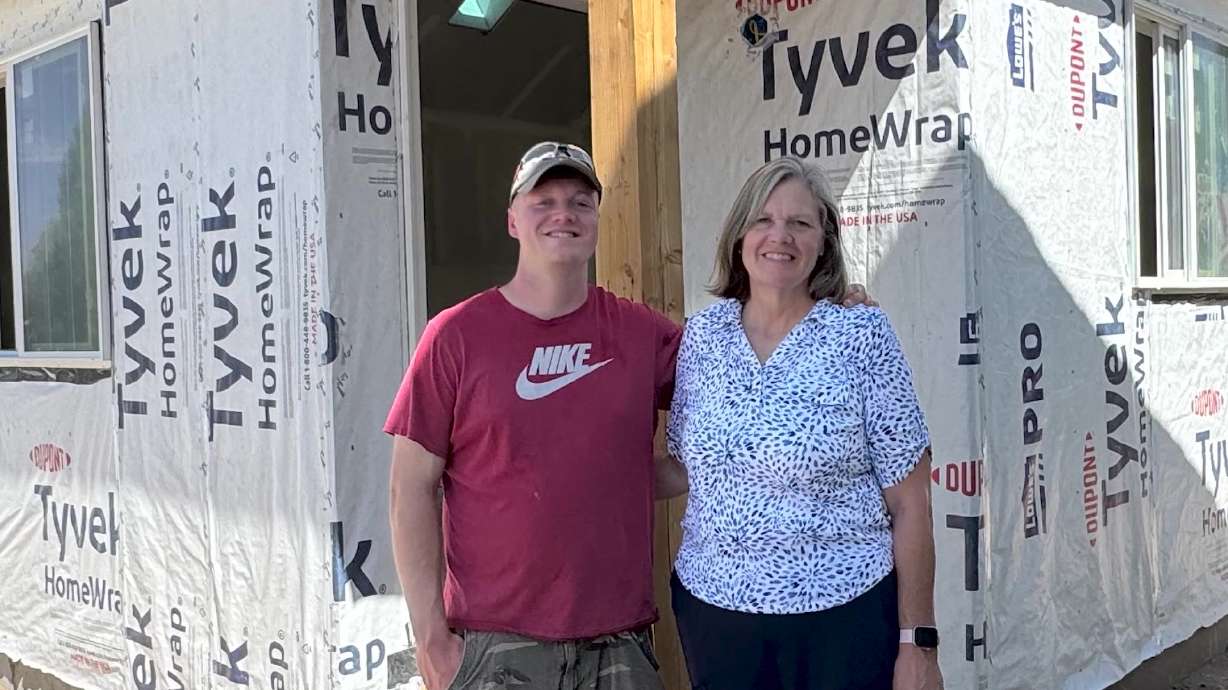 Luke Miller and his mother, KoShell Burnham, on Thursday, in front of an ADU being built for KoShell to move into.