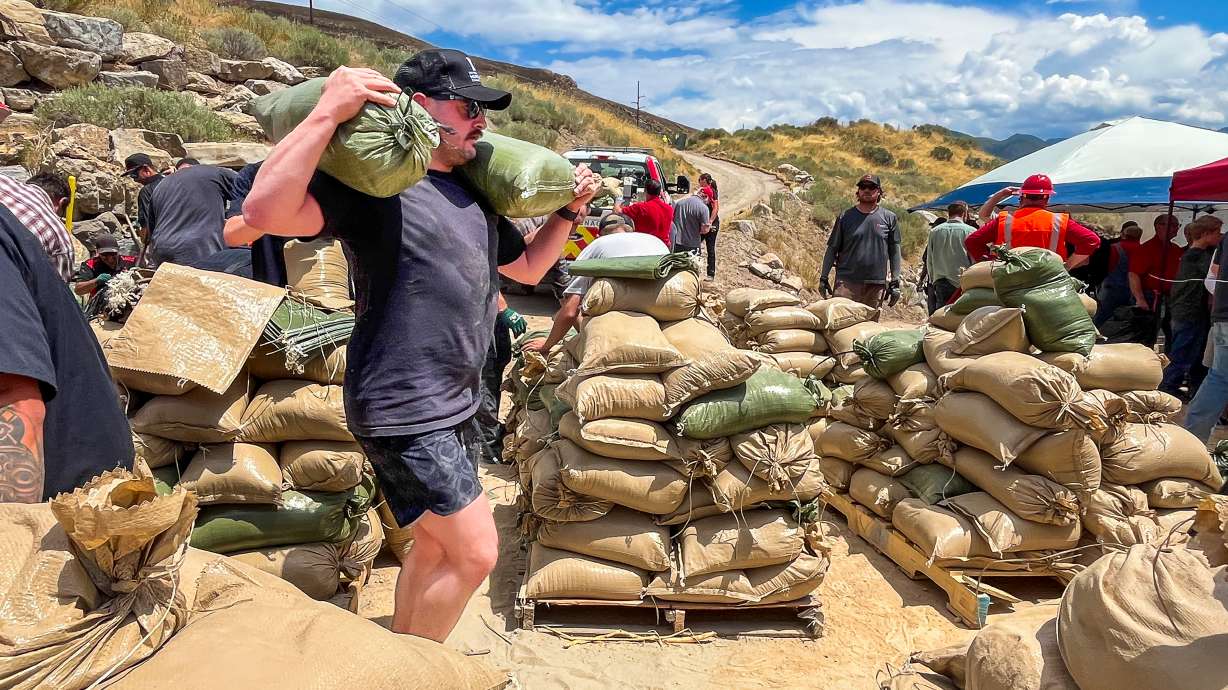 Volunteers fill sandbags near the Bonneville Fire burn scar in Salt Lake City on Thursday. Over 100 volunteers filled 2,000 sandbags that are being placed near the burn scar to help reduce flood impacts to mostly University of Utah Health buildings near where the fire burned last month.