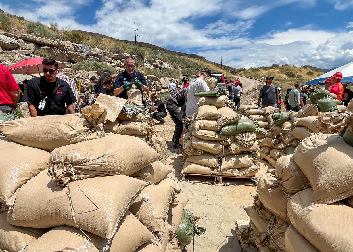 Volunteers fill sandbags near the Bonneville Fire burn scar in Salt Lake City on Thursday. Over 100 volunteers filled 2,000 sandbags that are being placed near the burn scar to help reduce flood impacts to mostly University of Utah Health buildings near where the fire burned last month.