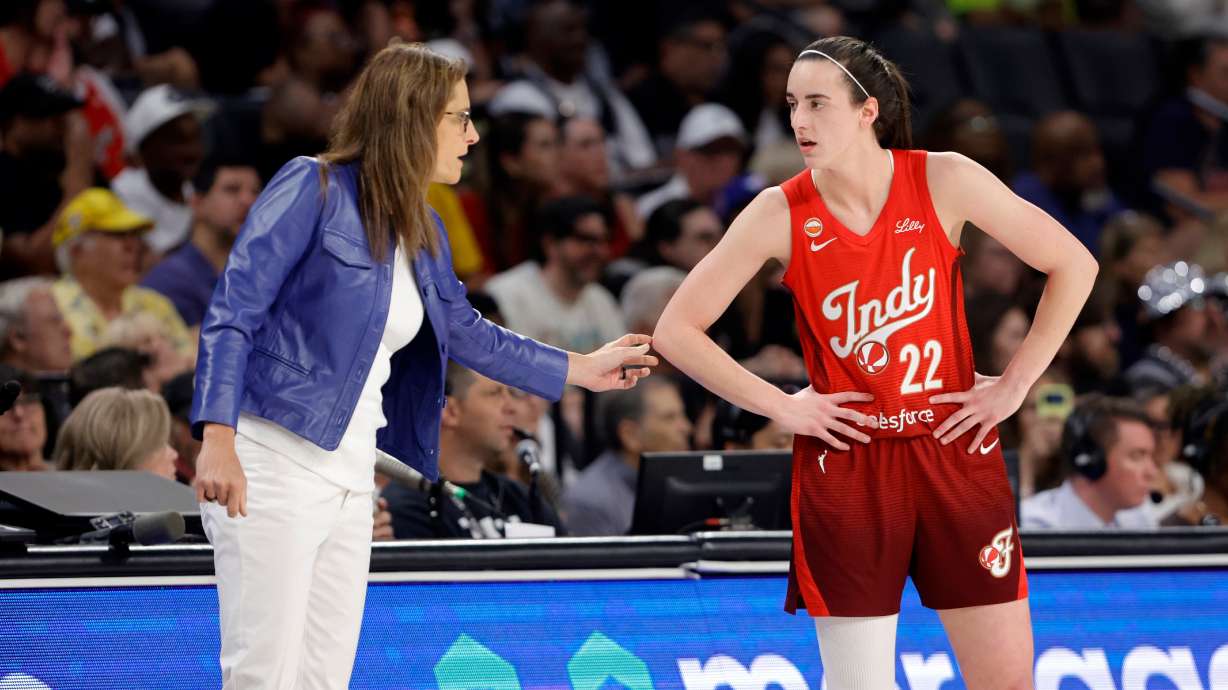 Indiana Fever head coach Stephanie White talks with Indiana Fever guard Caitlin Clark (22) during the first half of an WNBA basketball game against the Las Vegas Aces Sunday, July 12, 2026, in Las Vegas.
