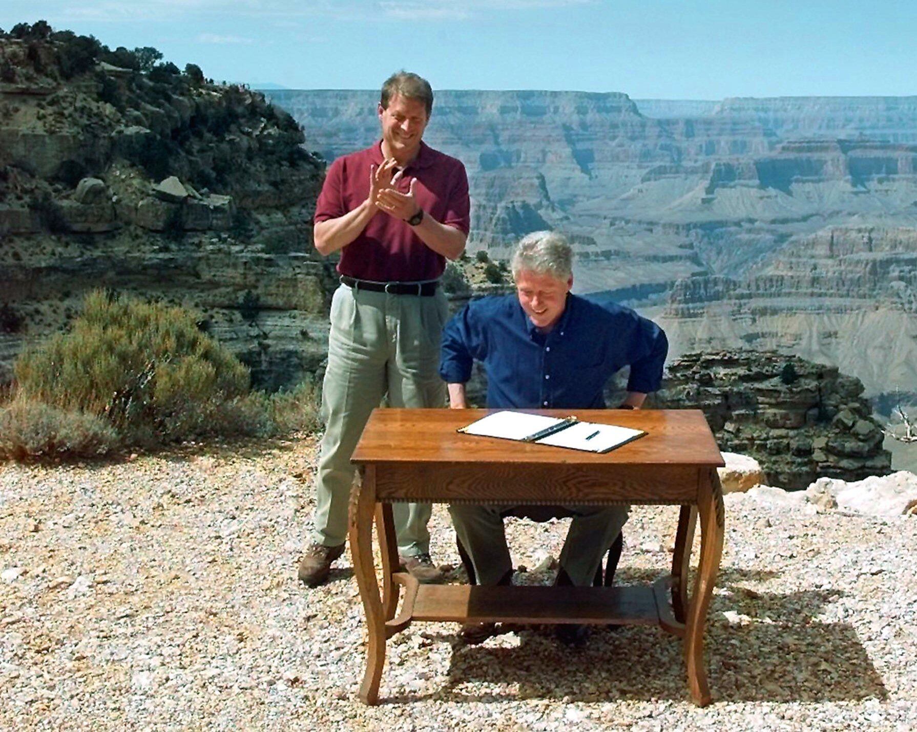 Vice President Al Gore applauds after President Bill Clinton signs a bill designating about 1.7 million acres of land in southern Utah's red-rock cliffs as the Grand Staircase-Escalante National Monument, at the Grand Canyon National Park in Arizona, Sept. 18, 1996. A recent pair of executive orders from President Donald Trump shrank the monument.