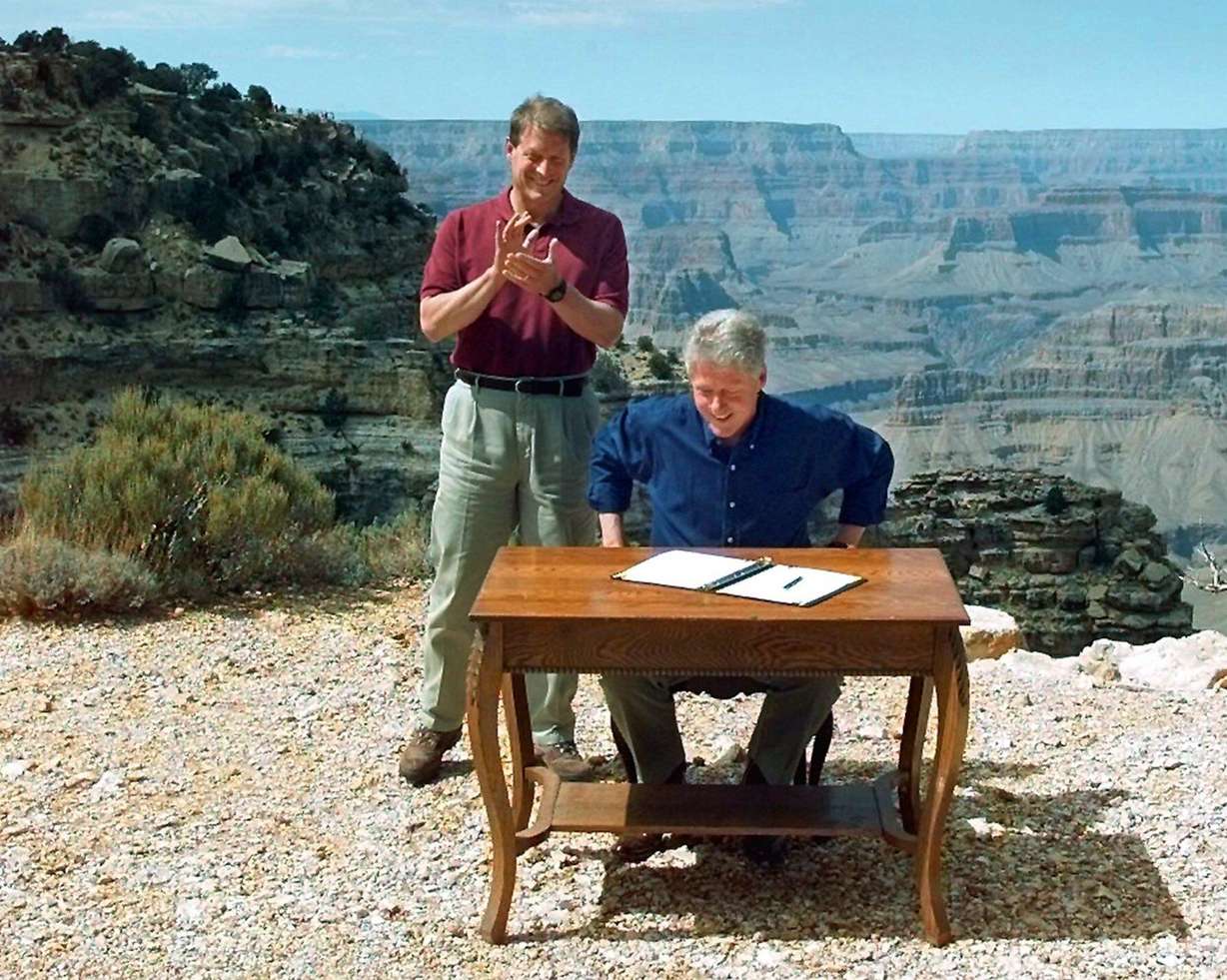 Vice President Al Gore applauds after President Bill Clinton signs a bill designating about 1.7 million acres of land in southern Utah's red-rock cliffs as the Grand Staircase-Escalante National Monument, at the Grand Canyon National Park in Arizona, Sept. 18, 1996. A recent pair of executive orders from President Donald Trump shrank the monument.