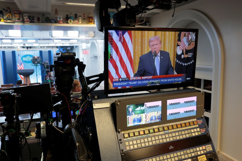 A screen plays U.S. President Donald Trump's address to the nation from the White House in Washington, D.C., Thursday.