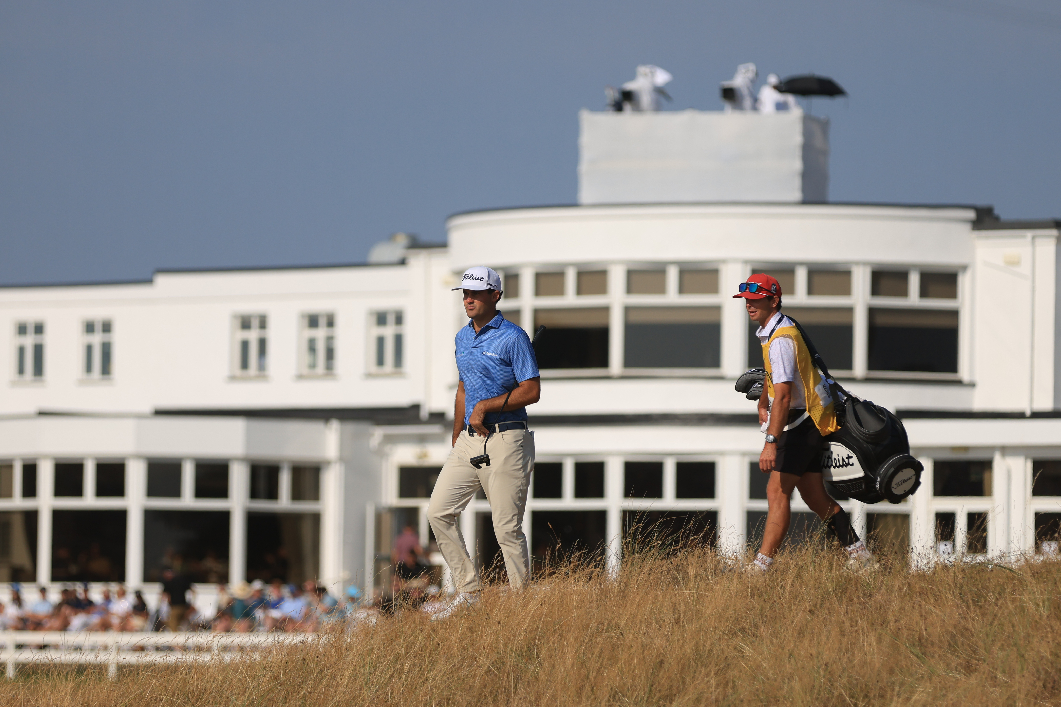 Jackson Suber of the United States, and his caddie Greyson Porter walks towards the 18th green during the first day of the British Open Golf championships at Royal Birkdale golf club, in Southport, England, Thursday, July 16, 2026. 