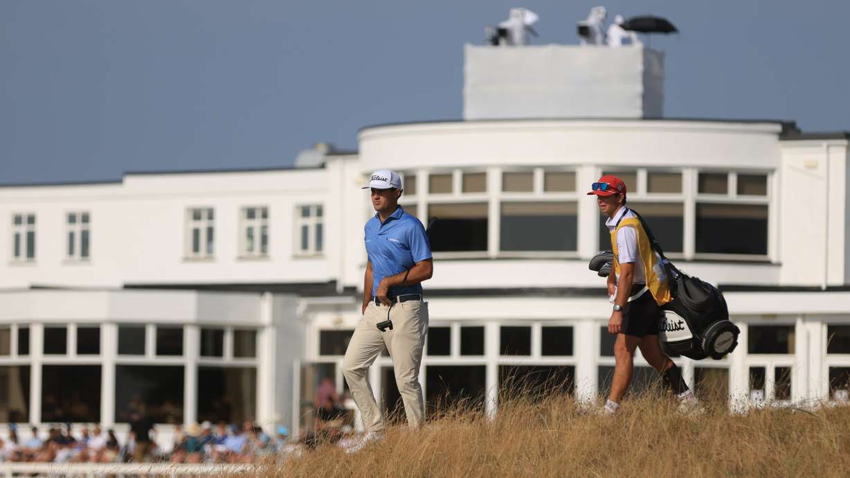 Jackson Suber of the United States, and his caddie Greyson Porter walks towards the 18th green during the first day of the British Open Golf championships at Royal Birkdale golf club, in Southport, England, Thursday, July 16, 2026.