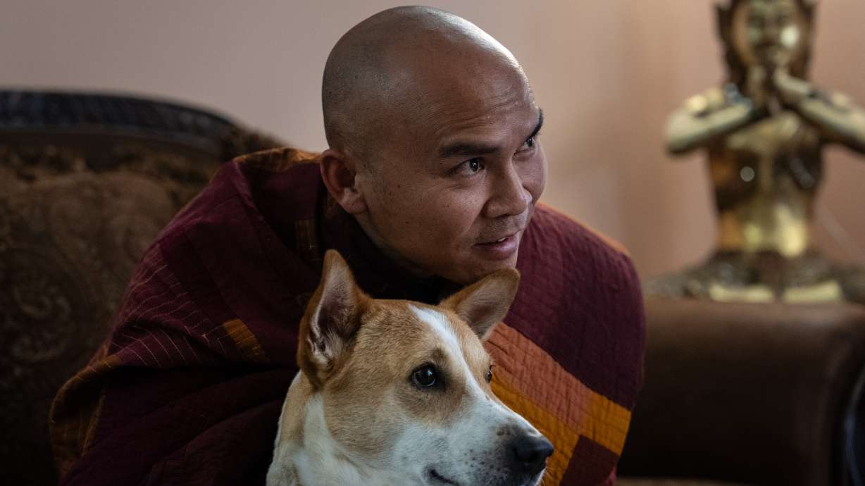 Bhikkhu Pannakara, a Buddhist monk who led a Walk for Peace from Fort Worth, Texas, to Washington, D.C., sits with his dog, Aloka, before an event at Wat Thai of Los Angeles in North Hollywood, Calif., Monday. Pannakara has been in the spotlight since the walk earlier this year.