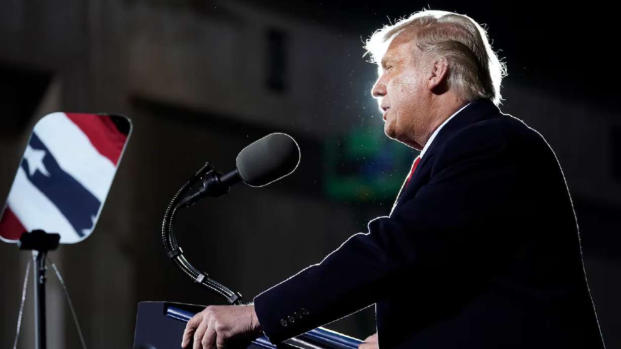 With the American flag reflected in the teleprompter, President Donald Trump speaks at a campaign rally at Duluth International Airport, Sept. 30, 2020, in Duluth, Minn. Utah Sen. John Curtis is renewing his insider trading crackdown after a White House teleprompter operator benefited from bets on Trump's speeches.
