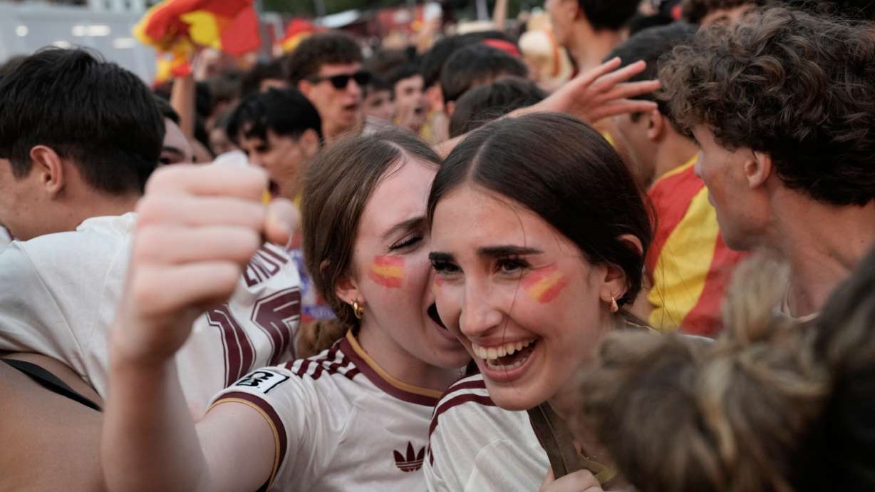 Spanish fans celebrate in central Madrid after Spain's Mikel Oyarzabal scores the opening goal on a penalty kick during the World Cup semifinal soccer match between France and Spain in Arlington, Texas, near Dallas, Tuesday, July 14, 2026.