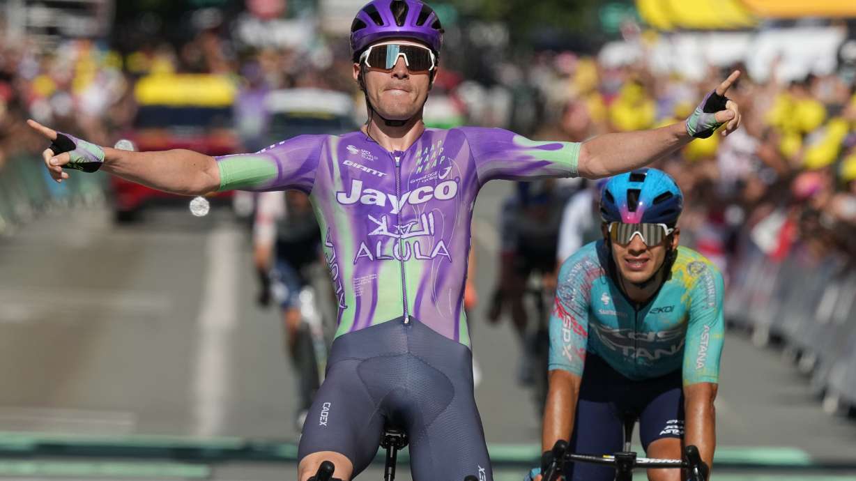 Switzerland's Mauro Schmid celebrates as he crosses the finish line ahead of Colombia's Harold Tejada, right, to win the thirteenth stage of the Tour de France cycling race with start in Dole and finish in Belfort, France, Friday, July 17, 2026.