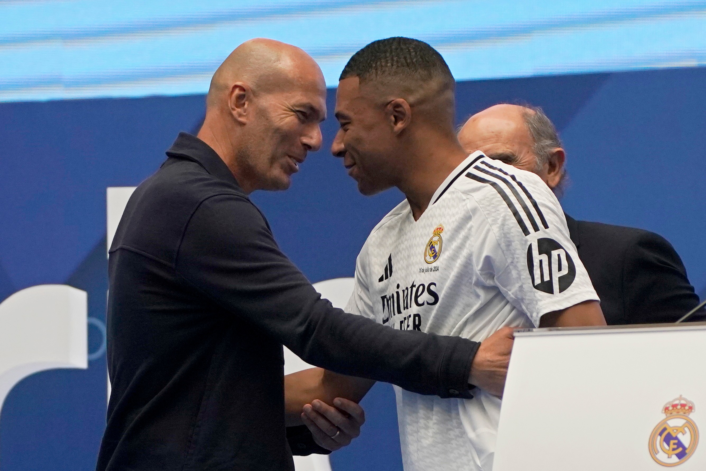 FILE - Former French player Zinedine Zidane, left, embraces Kylian Mbappe of France, as he is being presented to fans as a new Real Madrid player in Madrid, July 16, 2024. 