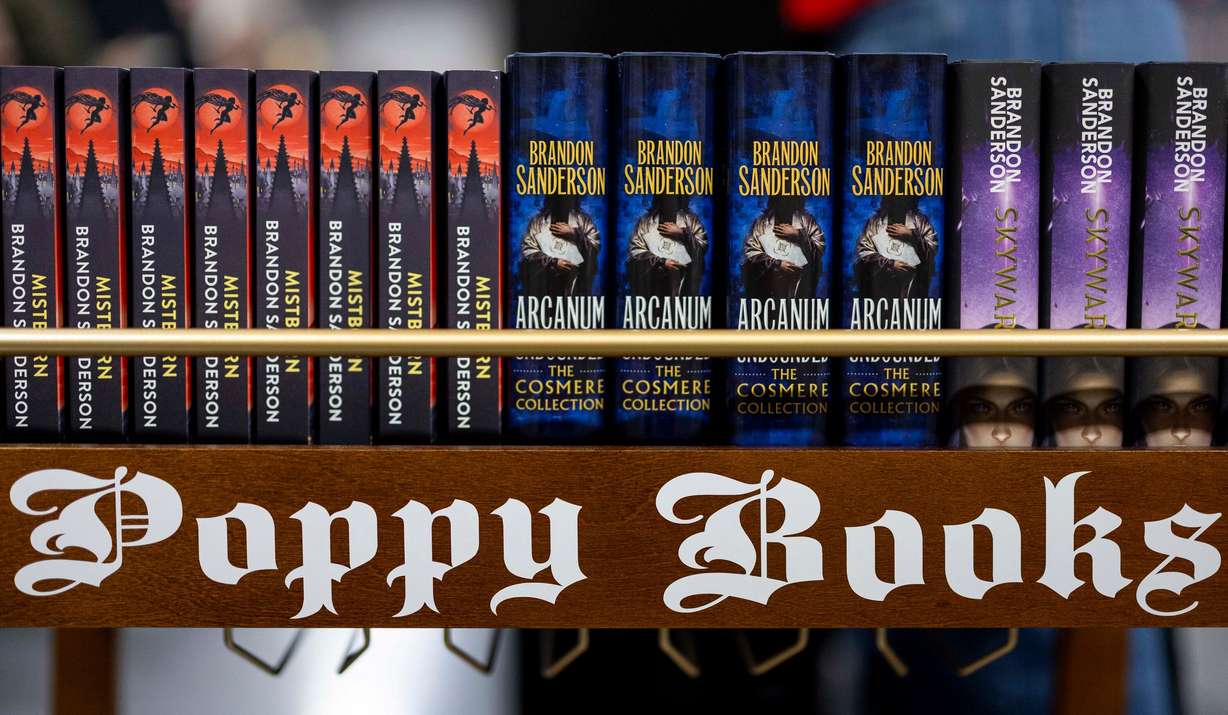A Poppy Books stand displays some of Brandon Sanderson’s books before a signing session during Dragonsteel Nexus at the Salt Palace Convention Center in Salt Lake City on Dec. 4. Sanderson's "Mistborn" series, on the left side of the stand, celebrated its 20th anniversary on Friday.