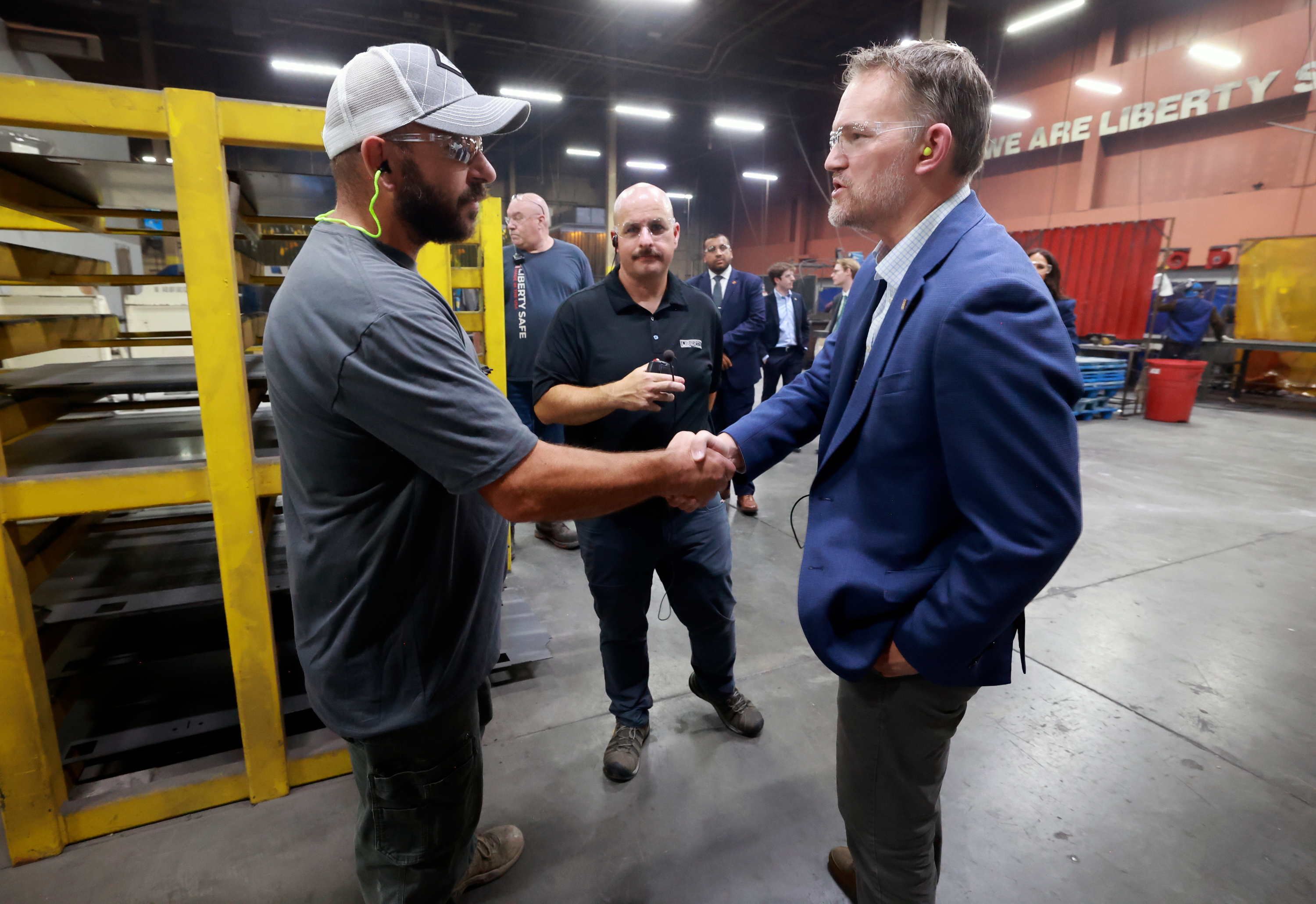 Daren Youngblood, Liberty Safe production manager, shakes hands with Trade Representative Jamieson Greer as Greer tours Liberty Safe with company COO Trevor Clements in Payson on Thursday. Greer sought to ramp up his new trade strategy this week.