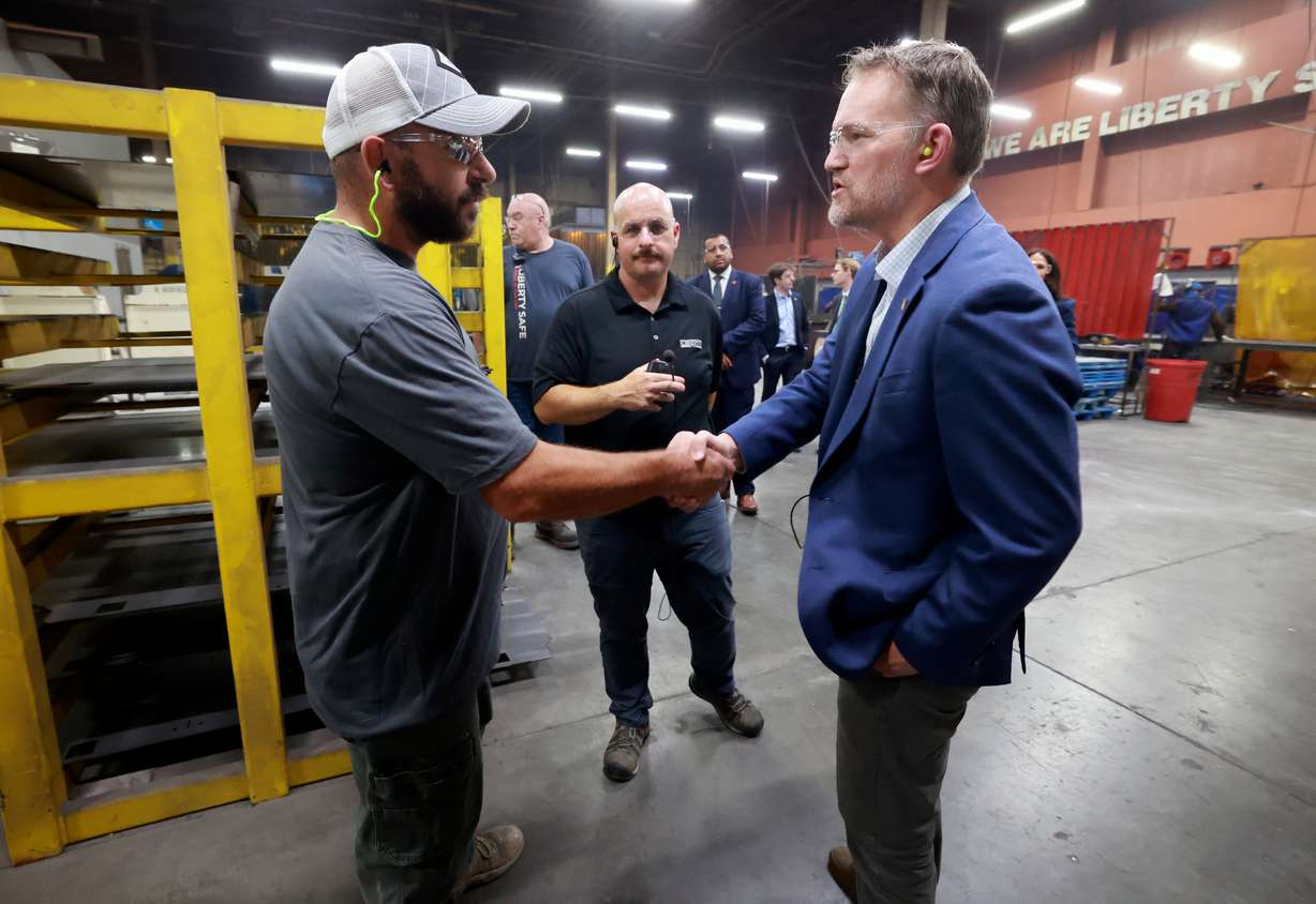 Daren Youngblood, Liberty Safe production manager, shakes hands with Trade Representative Jamieson Greer as Greer tours Liberty Safe with company COO Trevor Clements in Payson on Thursday. Greer sought to ramp up his new trade strategy this week.