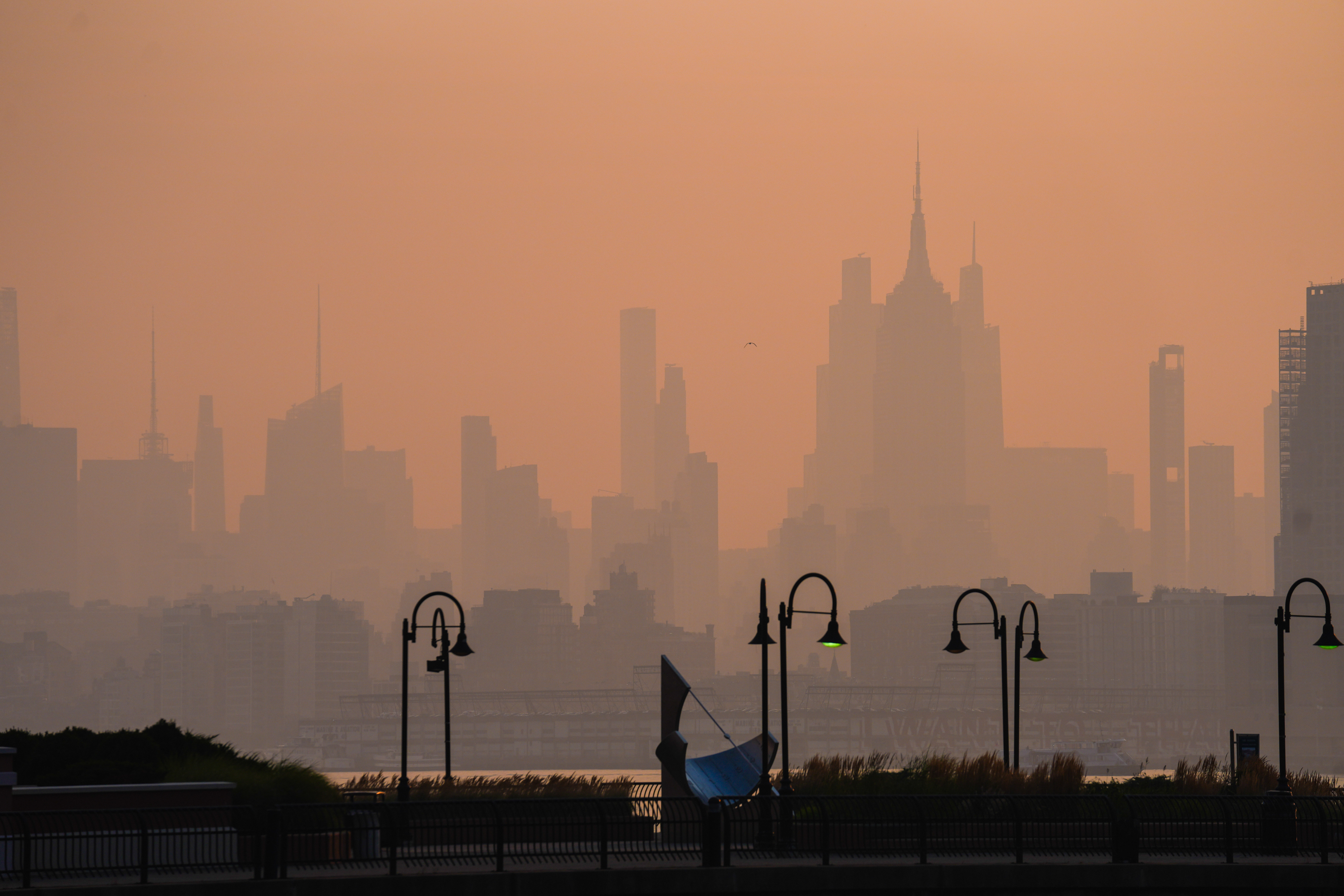 The New York City skyline is seen through a cover of wildfire smoke, in Jersey City, N.J., Friday, July 17, 2026. 