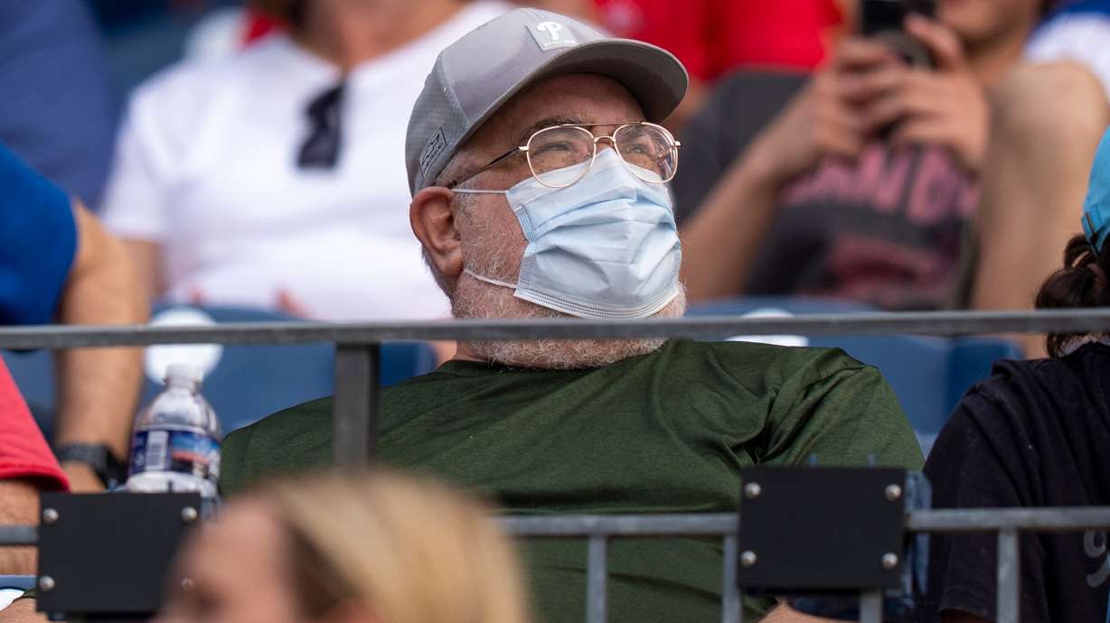 A fan wears a mask during an air quality warning from wildfire smoke prior to baseball game between the New York Mets and the Philadelphia Phillies, Thursday, July 16, 2026, in Philadelphia.