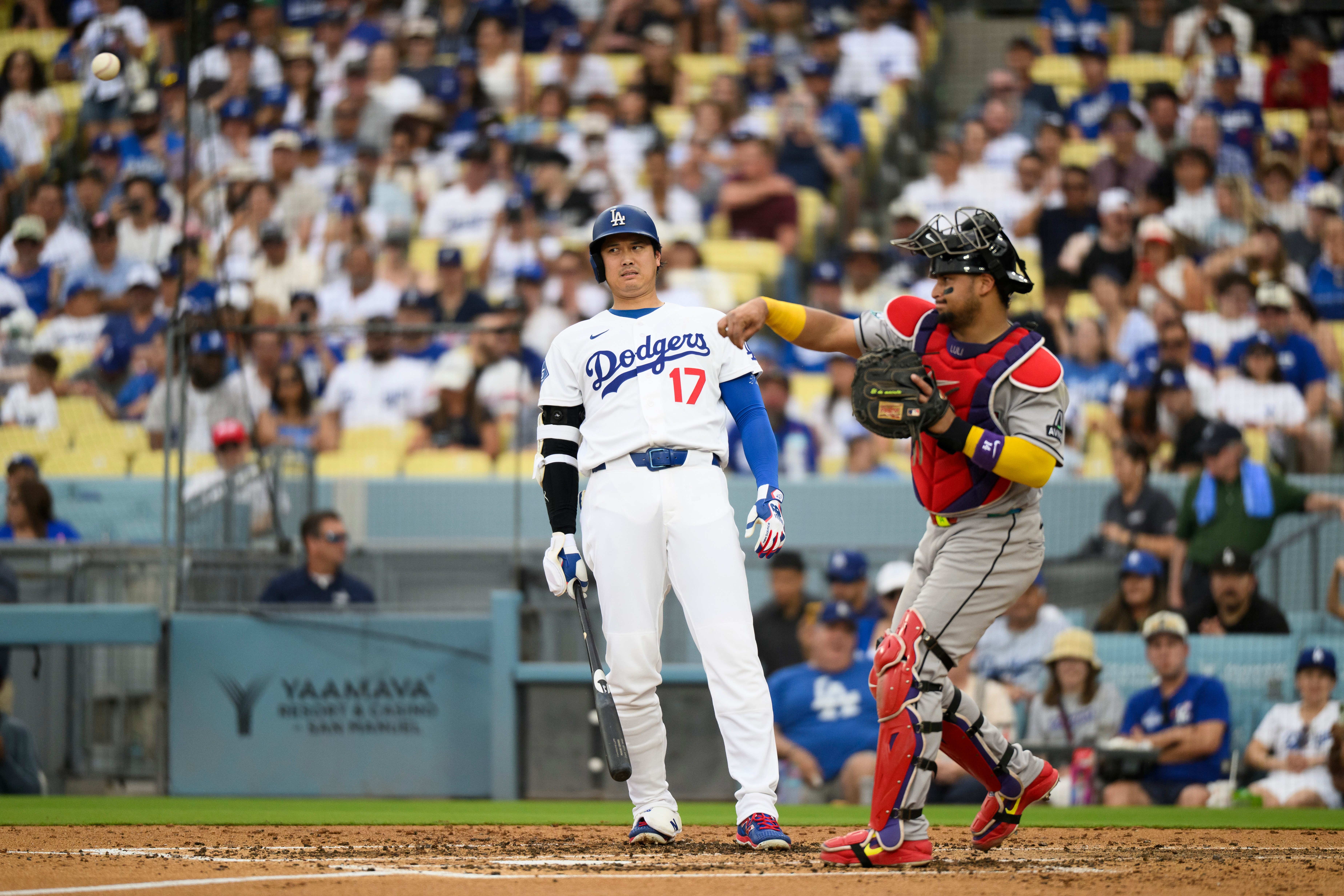 Los Angeles Dodgers' Shohei Ohtani (17) reacts as Arizona Diamondbacks catcher Gabriel Moreno throws during the third inning of a baseball game in Los Angeles, Sunday, July 12, 2026. 