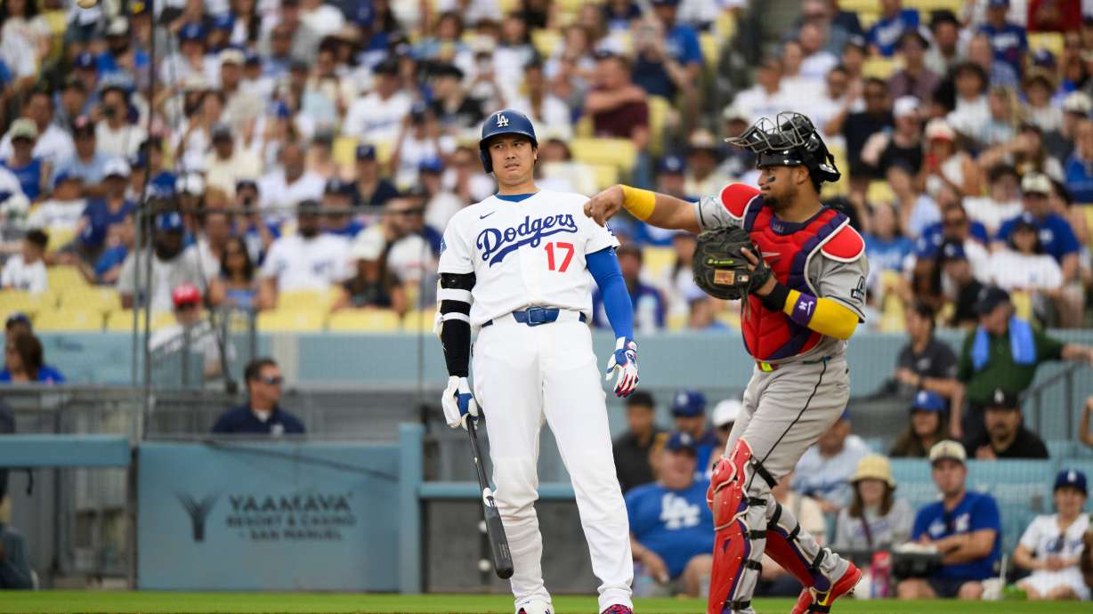 Los Angeles Dodgers' Shohei Ohtani (17) reacts as Arizona Diamondbacks catcher Gabriel Moreno throws during the third inning of a baseball game in Los Angeles, Sunday, July 12, 2026.