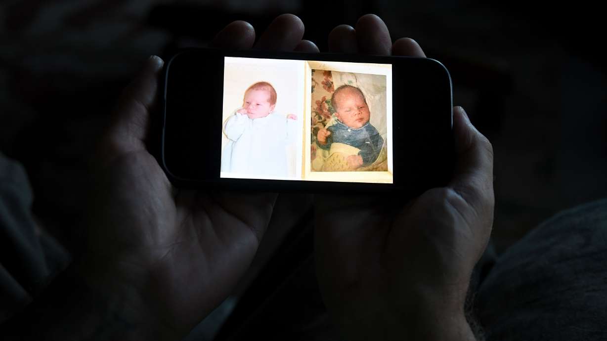 Jeremy Morrison, who says he was sent home with the wrong parents after he was born, shows what he believes is a baby photo of him, left, and of the other baby he says was switched at birth while recounting the story at his home in Colorado City, Colo., on Thursday.