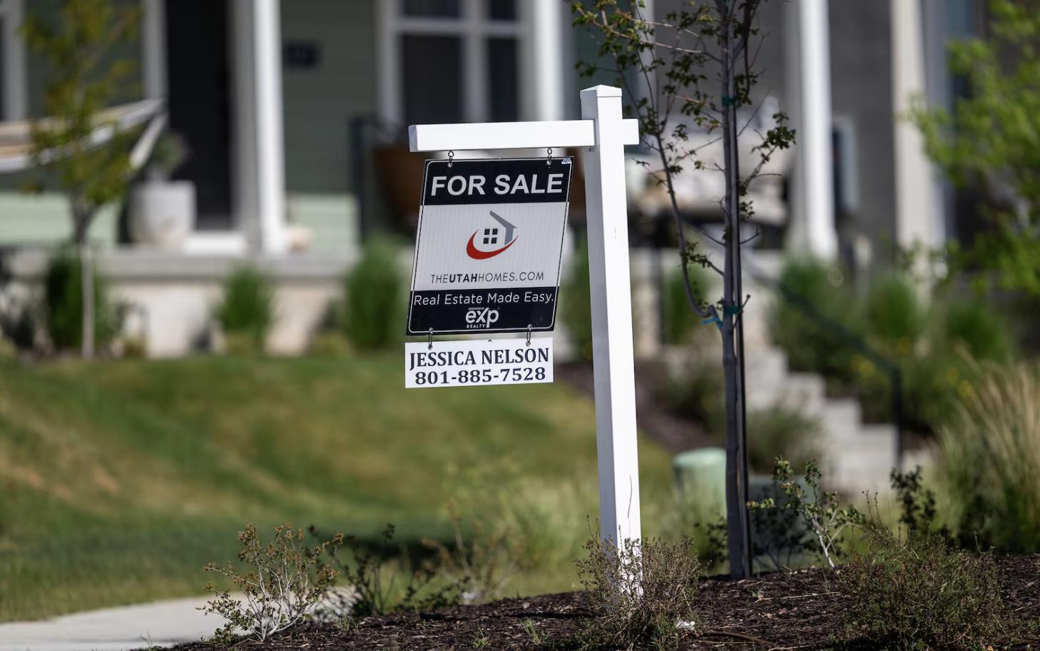 A for-sale sign stands in front of a home in Herriman on May 12.