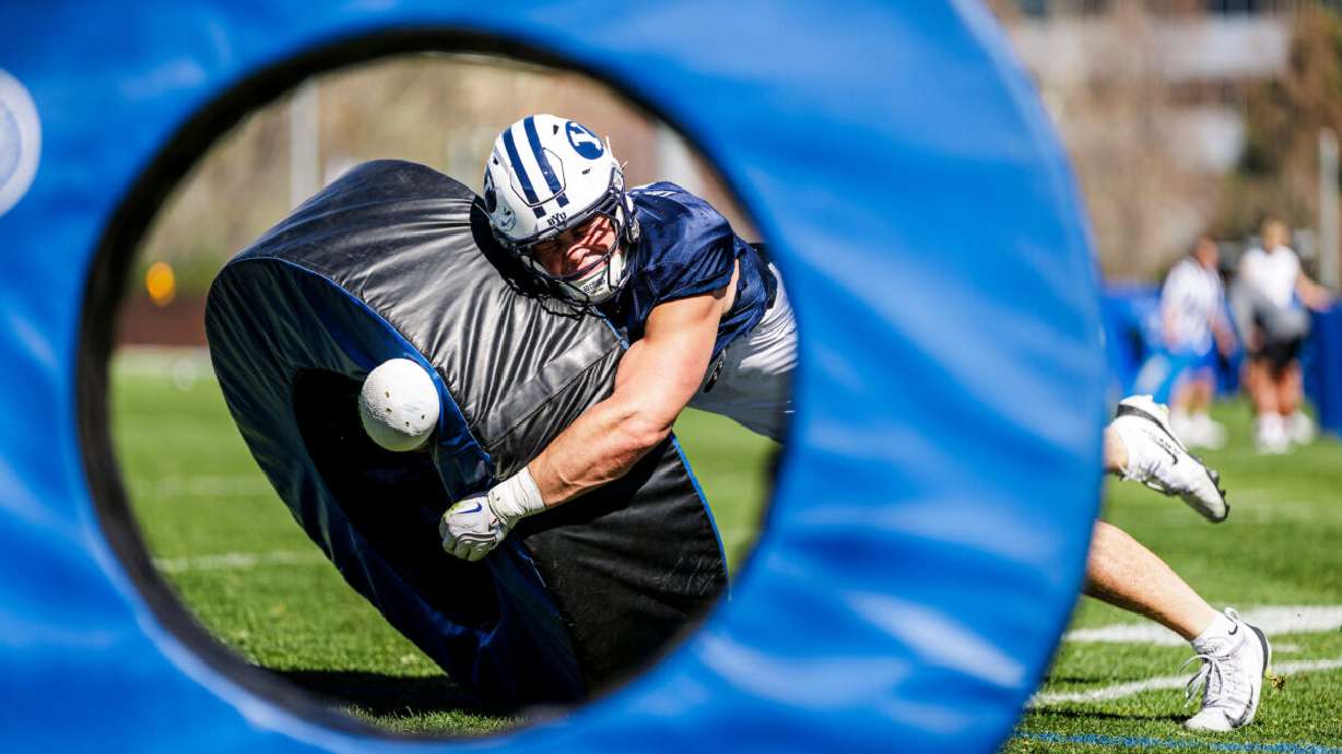 BYU linebacker Cade Uluave leans into a tackling drill during spring practices,March 25, 2026 in Provo, Utah. Uluave, a former Mountain Ridge High star, transferred to BYU after four years at Cal.