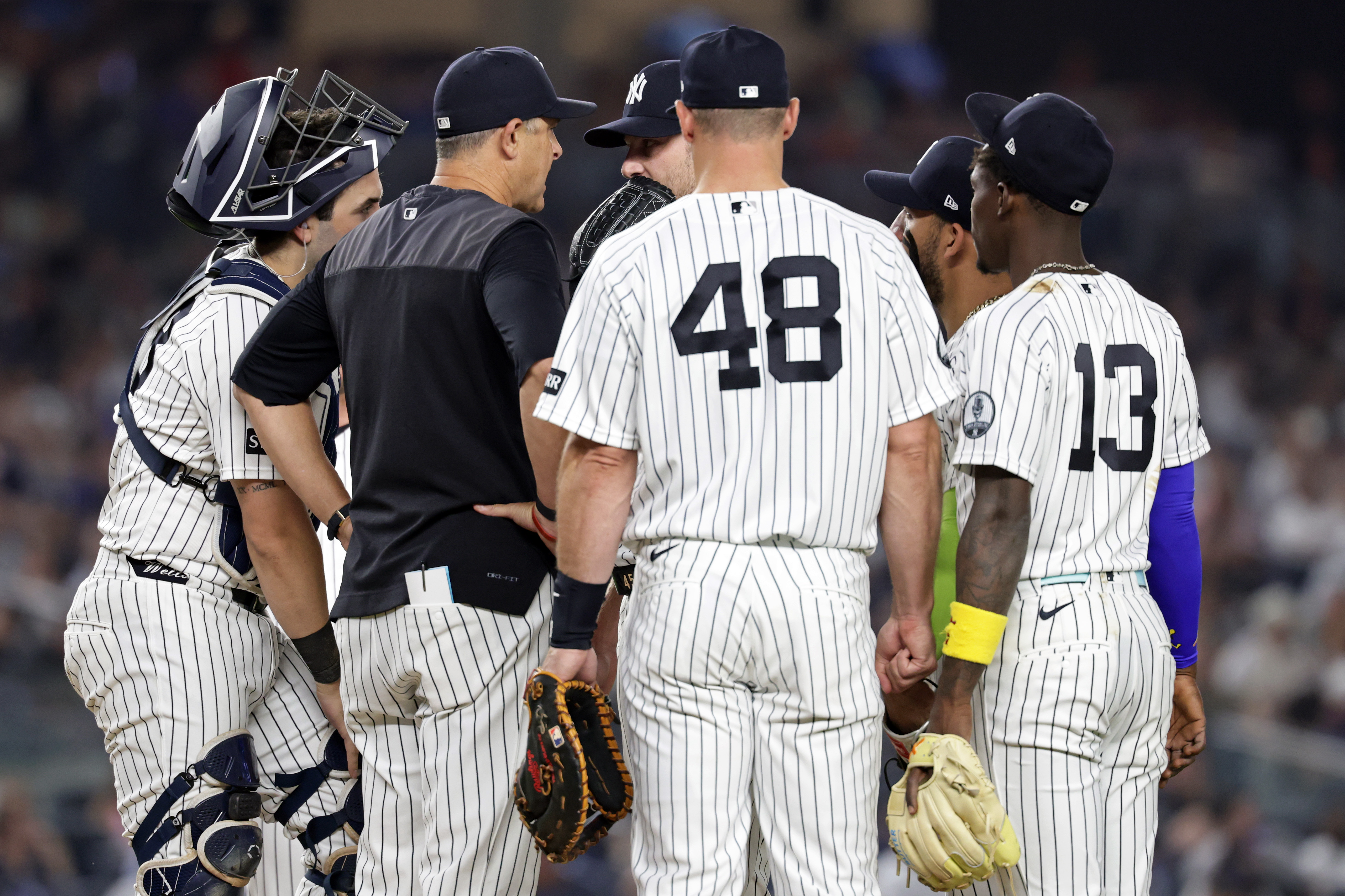 New York Yankees manager Aaron Boone, second left, confers with Gerrit Cole during the seventh inning of a baseball game against the Los Angeles Dodgers, Friday, July 17, 2026, in New York. 