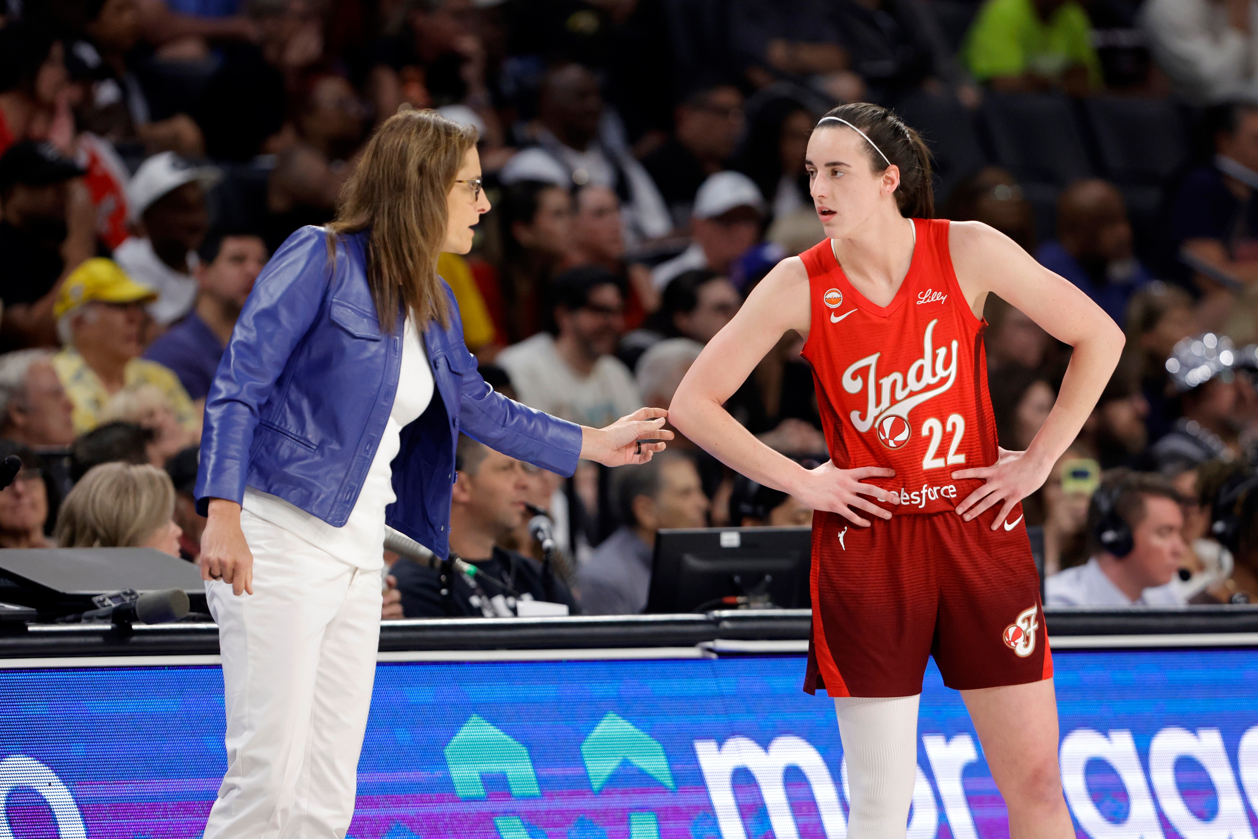 Indiana Fever head coach Stephanie White talks with Indiana Fever guard Caitlin Clark (22) during the first half of an WNBA basketball game against the Las Vegas Aces Sunday, July 12, 2026, in Las Vegas. 