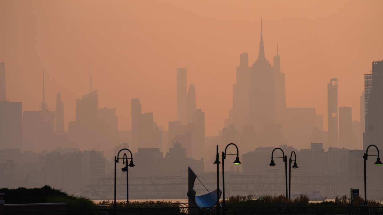 The New York City skyline is seen through a cover of wildfire smoke, in Jersey City, N.J., Friday, July 17, 2026.