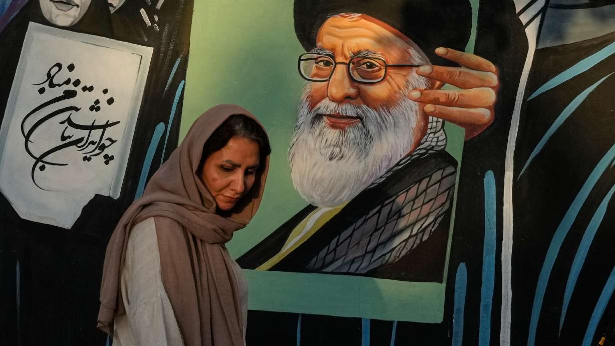 A woman walks past a mural depicting a portrait of the late Iranian Supreme Leader Ayatollah Ali Khamenei, who was killed in the U.S. and Israel strike on Feb. 28, in downtown Tehran, Iran, Saturday. The U.S. launched new airstrikes against Iran to punish the country's Revolutionary Guard for an attack in Jordan.