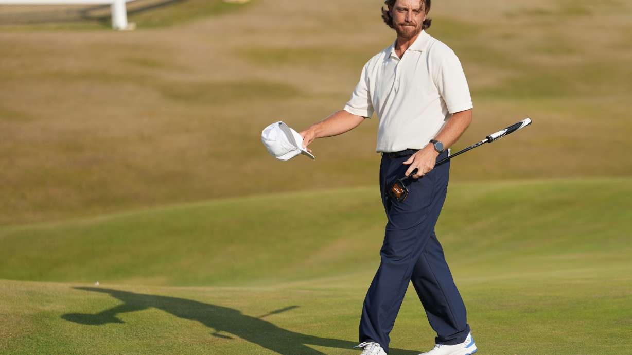Tommy Fleetwood of England reacts to the crowd on the 18th green after completing his third round during the third day of the British Open Golf championships at Royal Birkdale golf club, in Southport, England, Saturday, July 18, 2026.