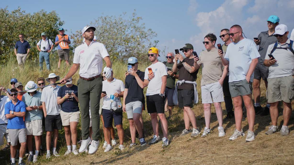 Sam Burns jumps up to try and see the pin on the 9th hole during the third day of the British Open Golf championships at Royal Birkdale golf club, in Southport, England, Saturday, July 18, 2026.