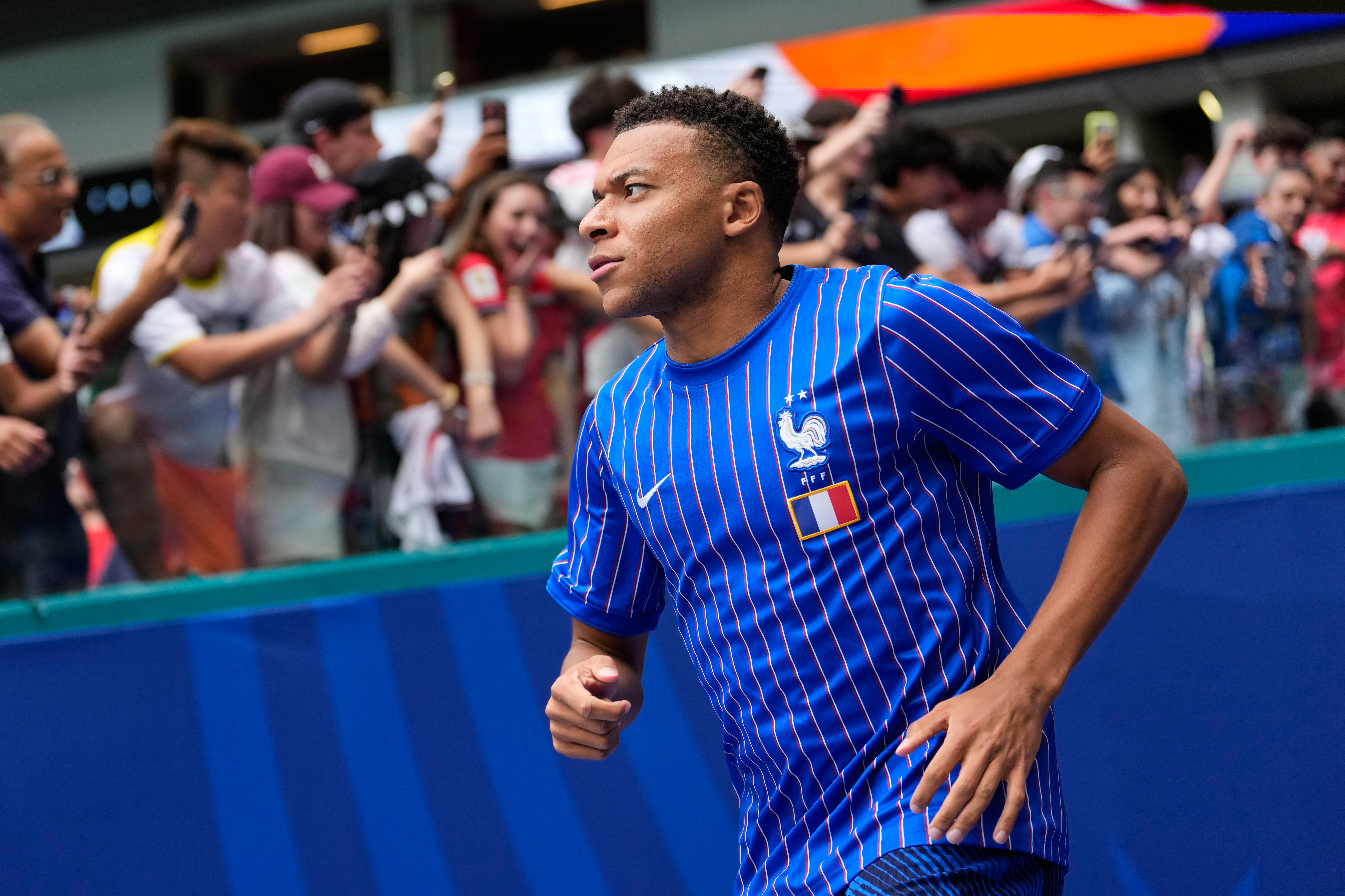 France's Kylian Mbappe jogs onto the field for warmups before the World Cup third-place playoff soccer match between France and England in Miami Gardens, Fla., Saturday, July 18, 2026. 